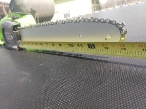 chains saw with measuring tape beside it
