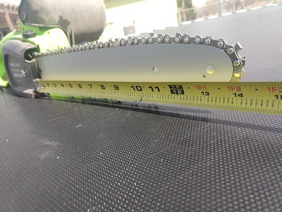 chains saw with measuring tape beside it