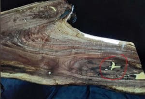 image of wood filler used on table with red circle