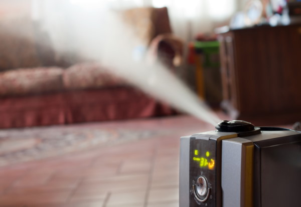 humidifier blowing steam over wood floor
