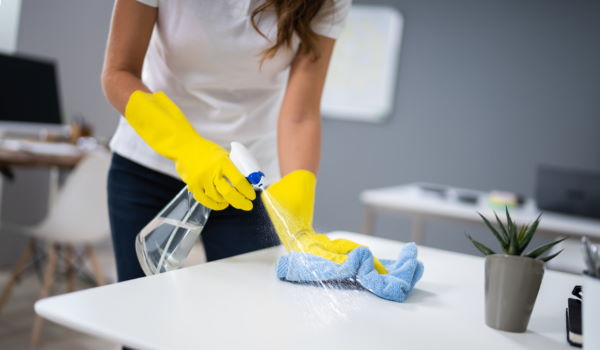 image of woman spraying and washing countertop