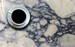 image of coffee cup sitting on stained quartz
