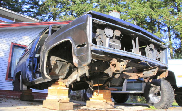 image of SUV disassembled and sitting on wood blocks
