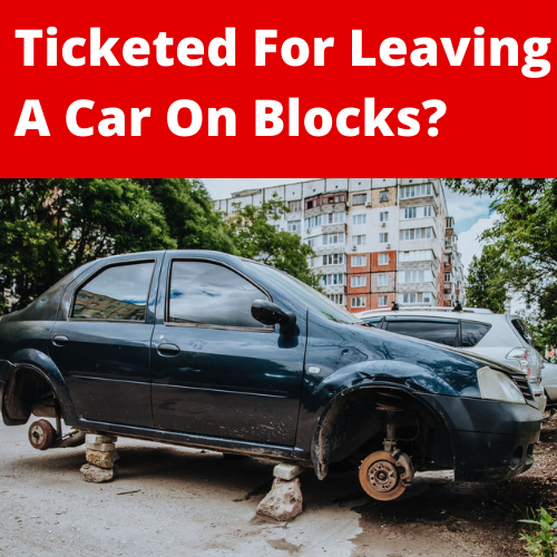 image of car on blogs with text: Ticketed For Leaving Car On Blocks?