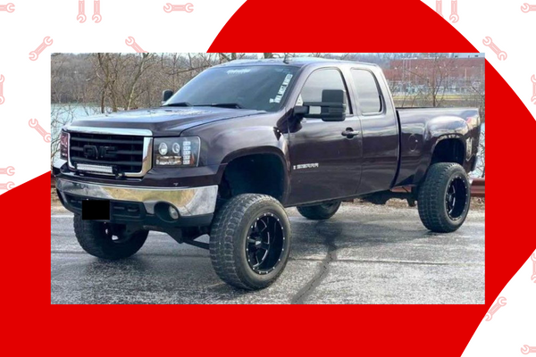 image of dark purple GMC truck with lift and blacked out grill